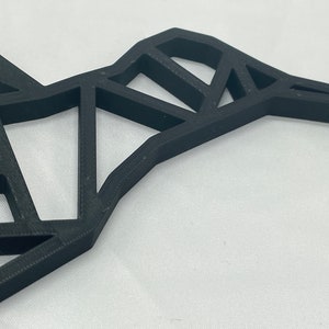 May include: A black geometric hummingbird wall decor made of 3D printed plastic.