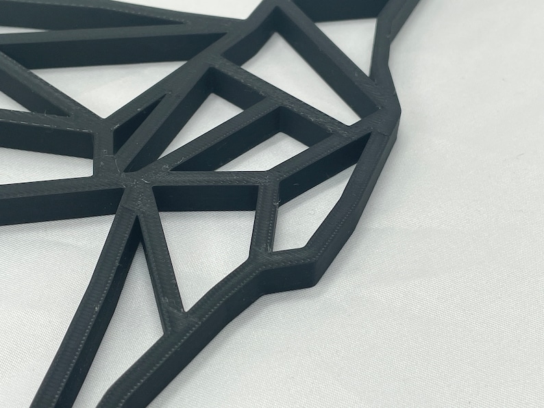 May include: A black geometric design with a 3D effect. The design is made of many triangles and squares that are connected together. The design is abstract and modern.
