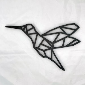 May include: Black geometric hummingbird wall decor. The hummingbird is made of metal and has a modern, minimalist design.