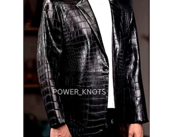 May include: Black leather blazer with a crocodile skin texture. The blazer has a notched lapel, a single-button closure, and a classic tailored fit. The text "POWER_KNOTS" is visible on the front of the blazer.