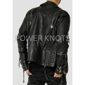 May include: Black leather motorcycle jacket with zipper details and a quilted design. The jacket has a stand-up collar, long sleeves, and a zipper closure. The jacket has a  "POWER KNOTS" logo on the back.