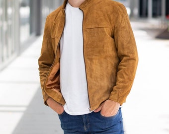 May include: A brown suede jacket with a zipper closure and a stand-up collar.