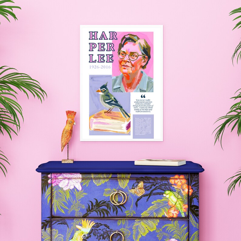 May include: A white framed poster with a pink background featuring a portrait of Harper Lee, the author of "To Kill a Mockingbird." The poster includes the text "Harper Lee 1926-2016" and a quote from Lee: "You never really understand a person until you consider things from his point of view...until you climb into his skin and walk around in it."