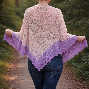 May include: A triangular knit shawl featuring a cream-colored upper section with a swirling lace pattern and a vibrant purple lower border with a textured, open-work stitch design. The shawl is draped over the shoulders and hangs to a point.