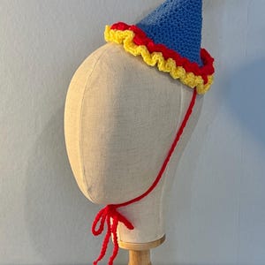 primary coloured clown hat with strap on a canvas mannequin head