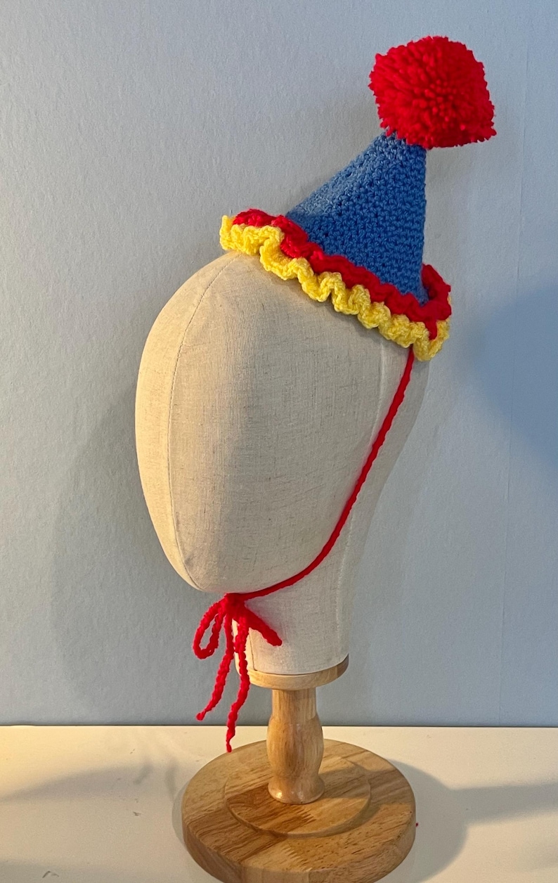 primary coloured clown hat with strap on a canvas mannequin head