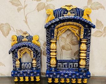 May include: Two decorative wooden frames painted in blue and gold. The larger frame is taller and wider than the smaller frame. Both frames have intricate carvings and a traditional design.