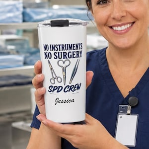 May include: A white stainless steel tumbler with a black lid featuring the blue text NO INSTRUMENTS NO SURGERY SPD CREW, illustrations of surgical tools, and the name Jessica in black script, held in front of a sterile medical storage area.