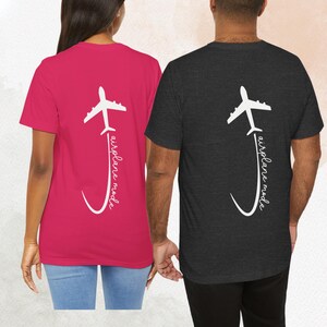 May include: Two t-shirts with a white airplane graphic and the text "airplane mode" on the back. One shirt is pink and the other is black.