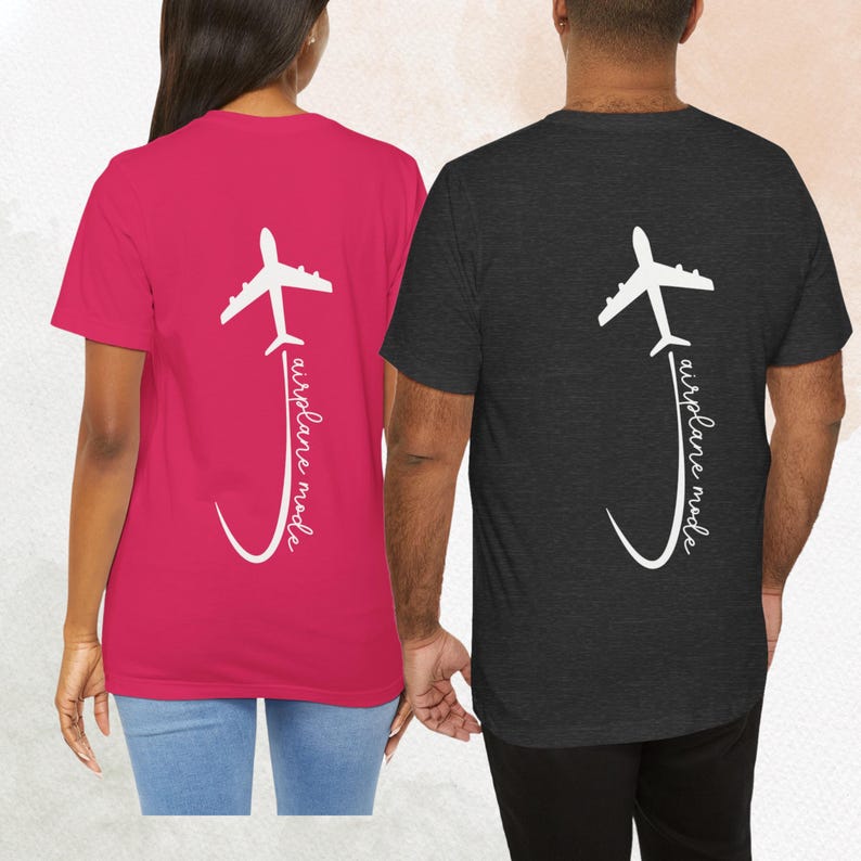 May include: Two t-shirts with a white airplane graphic and the text "airplane mode" on the back. One shirt is pink and the other is black.
