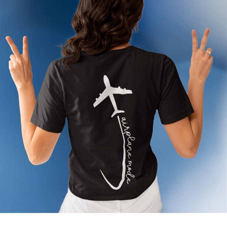 May include: Black t-shirt with a white airplane graphic and the text "airplane mode" written vertically.