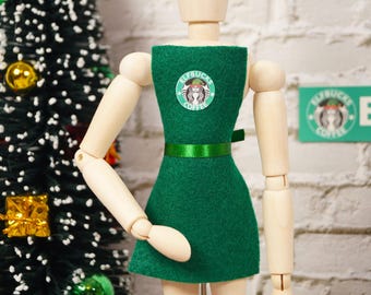 May include: A green dress with a white and green logo that says "Elfbucks Coffee".