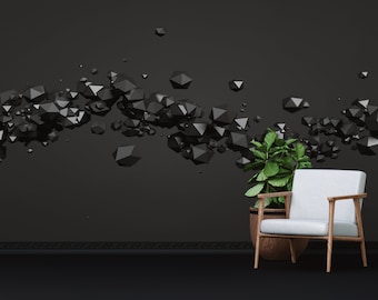 May include: A white armchair with wooden legs sits in front of a dark gray wall with a geometric pattern of black 3D shapes. A potted green plant is next to the chair.