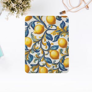 May include: A white background with a blue and yellow pattern of lemons and leaves. The lemons are yellow and the leaves are blue. The pattern is repeated throughout the image.