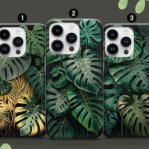 Könnte beinhalten: Drei Handyhüllen mit tropischem Blätterdesign. Die Hüllen sind schwarz mit grünen und goldenen Blättern. Die Hüllen sind mit 1, 2 und 3 nummeriert.