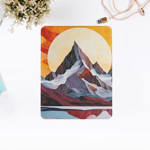 May include: A digital illustration of a mountain range with a large yellow sun behind it. The mountain range is made up of different shades of blue, purple, and brown. The sun is surrounded by a red and orange sky.