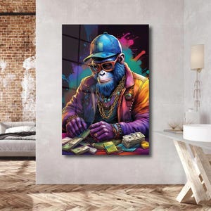 May include: A colorful illustration of a monkey wearing a blue baseball cap, sunglasses, and a gold chain. The monkey is sitting at a table with stacks of money in front of it.