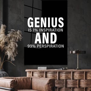 May include: Black and white motivational quote on a black background. The quote reads "Genius is 1% inspiration and 99% perspiration."