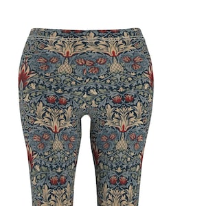 May include: Blue leggings with a repeating pattern of stylised flowers, leaves, and birds in shades of beige, red, and blue.