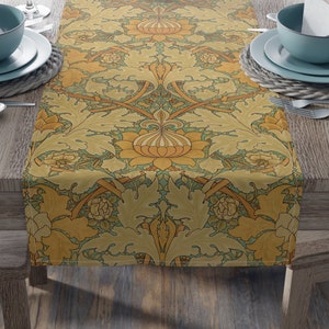 May include: A yellow and green table runner with a floral pattern. The runner is on a wooden table with two place settings on each side.