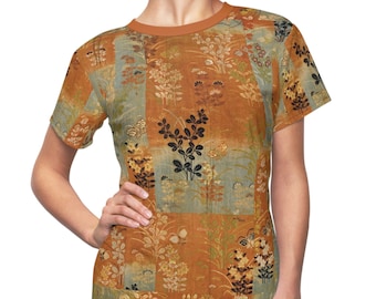 May include: A short-sleeved t-shirt with a colorful floral pattern. The pattern is a patchwork of different floral designs in shades of orange, yellow, and blue.