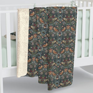 May include: A soft, plush throw blanket with a vintage floral pattern featuring birds and leaves in shades of blue, green, red, and yellow. The blanket has a white sherpa lining.