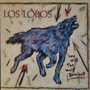 May include: A blue wolf with red spots is howling against a tan background with green and red lines. The text "LOS LOBOS" is at the top of the image. The text "how will the wolf Survive?" is at the bottom of the image.