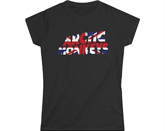 May include: Black t-shirt featuring the band name "Arctic Monkeys" in a stylized font. The text is filled with a Union Jack design in red, white, and blue. The shirt has short sleeves and a crew neck.