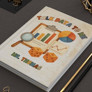 May include: A white notebook with a colourful design featuring the text "Talk Data To Me" and "Mr. Thomas". The design includes a magnifying glass, a chart, a pie chart, and dice.