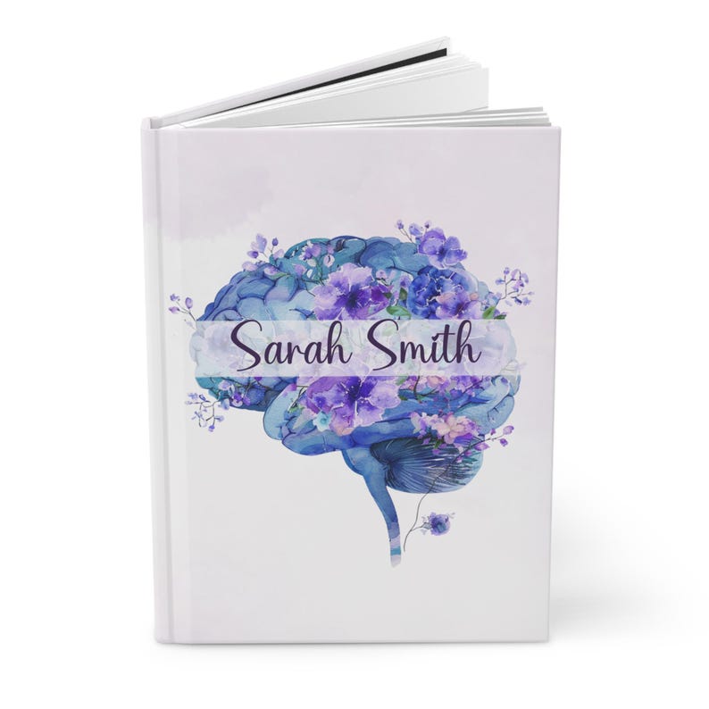 Watercolor Brain Art Journal with floral brain anatomy design. Features birth month floral patterns, customizable name option, perfect for psychology students, medical students, neurologists, ICU nurses, and neurosurgery professionals. Ideal for note-taking, therapy sessions, and cognitive science studies. Personalized journal celebrating brain anatomy and neuroscience.