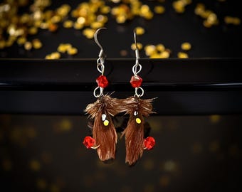 A brown Hornberg pair of fly fishing earrings. 4 brilliant red Swarovski beads attached to the cut barb.  Makes a perfect gift !