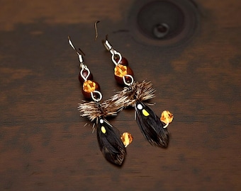 A black Hornberg pair of fly fishing earrings. 4 brilliant dark sunflower Swarovski Crystal beads attached to the cut barb