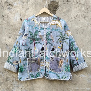 May include: A blue quilted jacket with a white and black striped trim. The jacket features a variety of animal and plant prints, including zebras, birds, and palm trees.