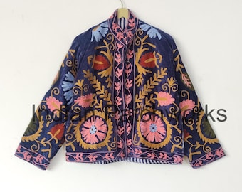 May include: A navy blue jacket with intricate floral embroidery in shades of pink, red, gold, and blue. The jacket features a collarless design and is likely made of a soft, velvet-like material. The embroidery is detailed and covers the entire jacket.