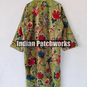 May include: A green velvet robe with a floral print. The robe has a mandarin collar and long sleeves. The text "Indian Patchworks" is visible on the robe.