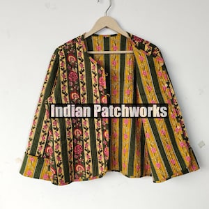 May include: A patterned jacket with a floral and striped design in green, yellow, and pink. The jacket features a round collar and button fastenings. The text "Indian Patchworks" is displayed on the front.