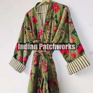 May include: Olive green velvet robe with a floral pattern in pink and red. The robe has a matching belt and striped cuffs. The text "Indian Patchworks" is across the front of the robe.