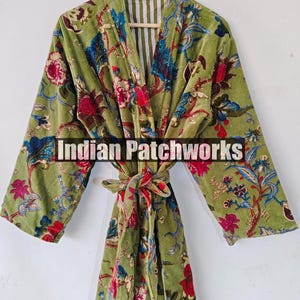 May include: A green velvet robe with a floral print. The robe has a tie belt and a striped lining. The text "Indian Patchworks" is visible on the robe.