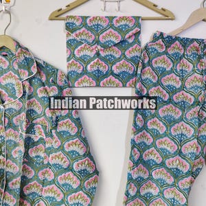 May include: A pajama set with a floral pattern in teal, pink, and white. The set includes a button-down shirt, pants, and a matching pouch. The text "Indian Patchworks" is visible.