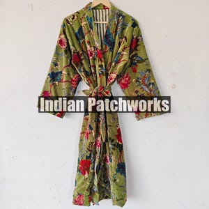 May include: A green velvet robe with a floral print. The robe has a tie belt and a white and green striped lining. The text "Indian Patchworks" is visible on the robe.