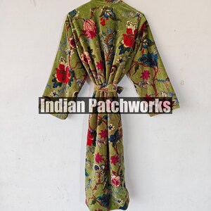 May include: A green velvet robe with a floral print. The robe has a tie belt and long sleeves.
