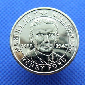May include: Silver coin with a portrait of Henry Ford, the text "Makers of the Millennium" and the years 1863 and 1947.