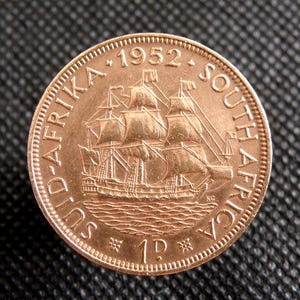 Moneta da un penny del Sud Africa del 1952: Re Giorgio VI, disegno di una nave a vela