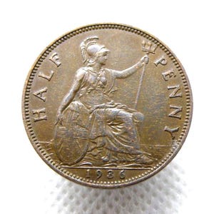 May include: A bronze-colored 1936 Half Penny coin. The coin features a seated woman holding a trident and shield. The words "HALF PENNY" and "1936" are visible around the edges.