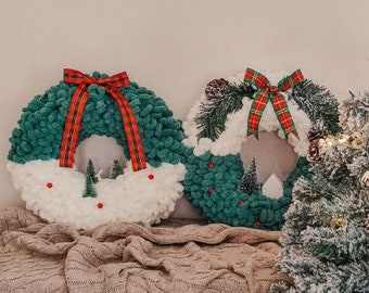 X-mas interior craft decor wreaths for the front door and a punch needle knited garland of mittens and socks with a rug rabbit cozy winter