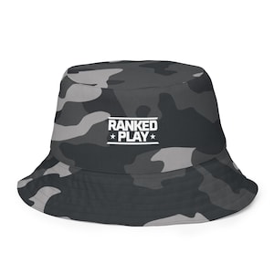 May include: A black and gray camouflage bucket hat with the text "RANKED PLAY" in white.