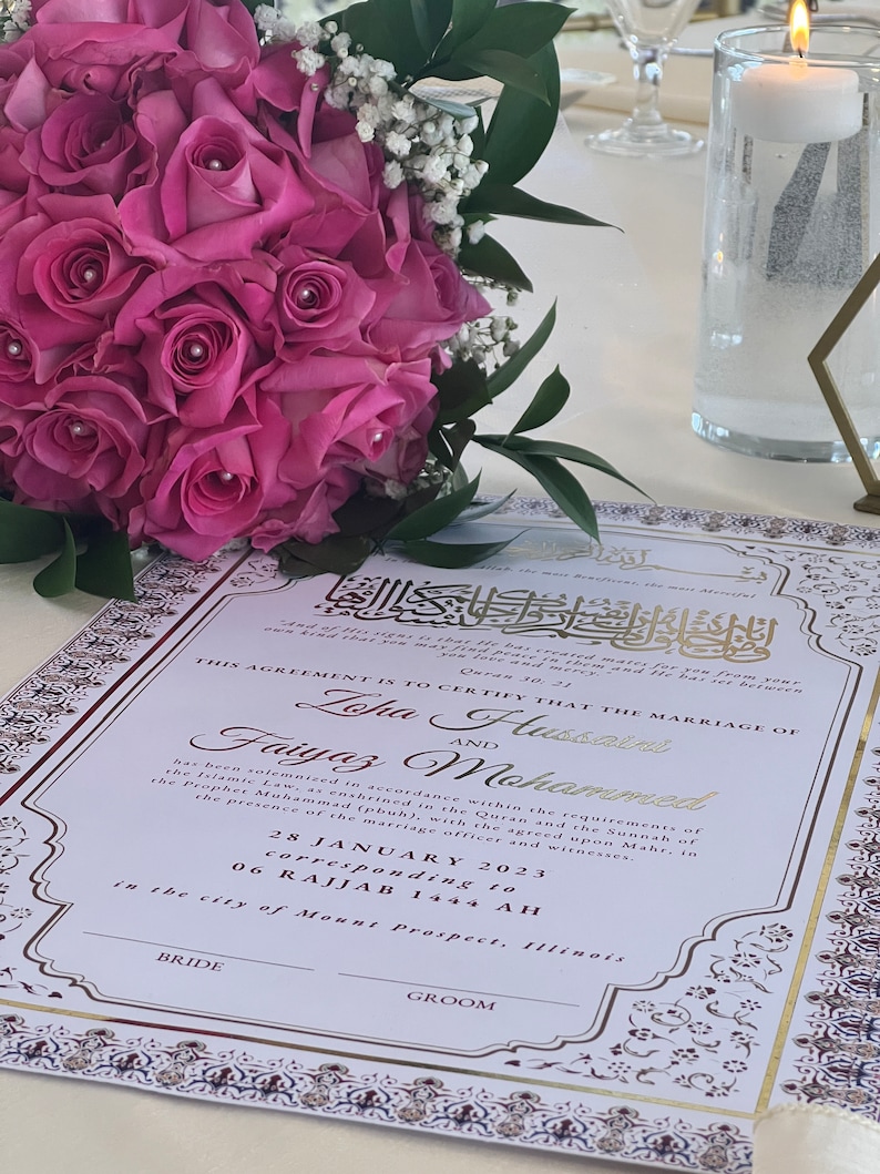 May include: A white wedding certificate with gold and burgundy accents. The certificate states "This agreement is to certify that the marriage of Lopa Husain and Faiyaz Mohammed has been solemnised in accordance within the requirements of the Islamic Law, as enshrined in the Quran and the Sunnah of the Prophet Muhammad (pbuh), with the agreed upon Mahr, in the presence of the marriage officer and witnesses. 28 January 2023 corresponding to 06 Rajjab 1444 AH in the city of Mount Prospect, Illinois."