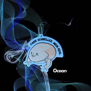 May include: Blue car air freshener with a cartoon frog and the text "FAHR SCHNELLER, MEIN KERL" and the word "Ocean" below the frog.