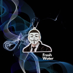 May include: A white car air freshener with a black and white illustration of a person wearing a mask. The text "Fresh Water" is printed below the illustration.