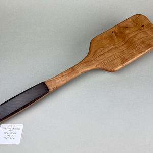 May include: A set of three ceramic mugs with a speckled, matte finish. The mugs are in shades of cream, light gray, and dark gray. Each mug has a simple, minimalist design, perfect for coffee or tea.